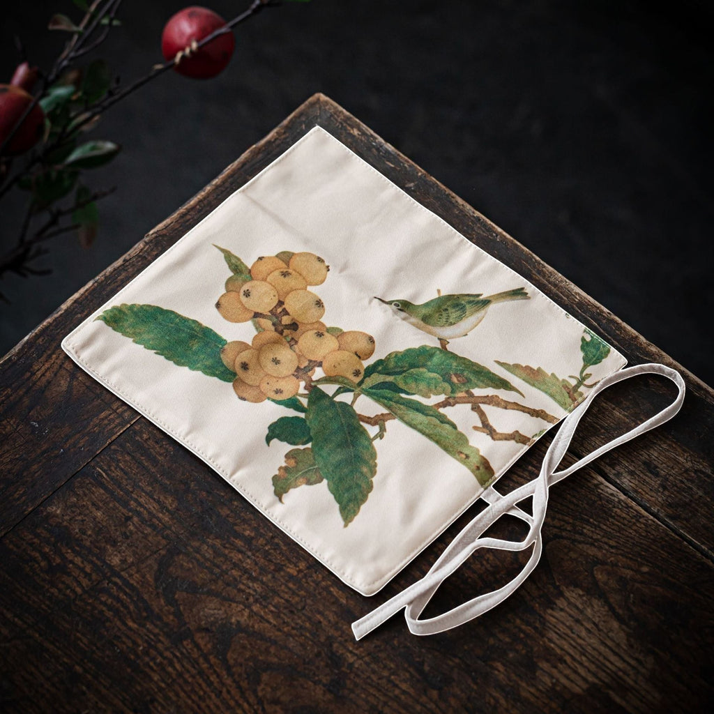 Loquat Bird Gong Fu Cha travel mat displayed on a wooden tea table