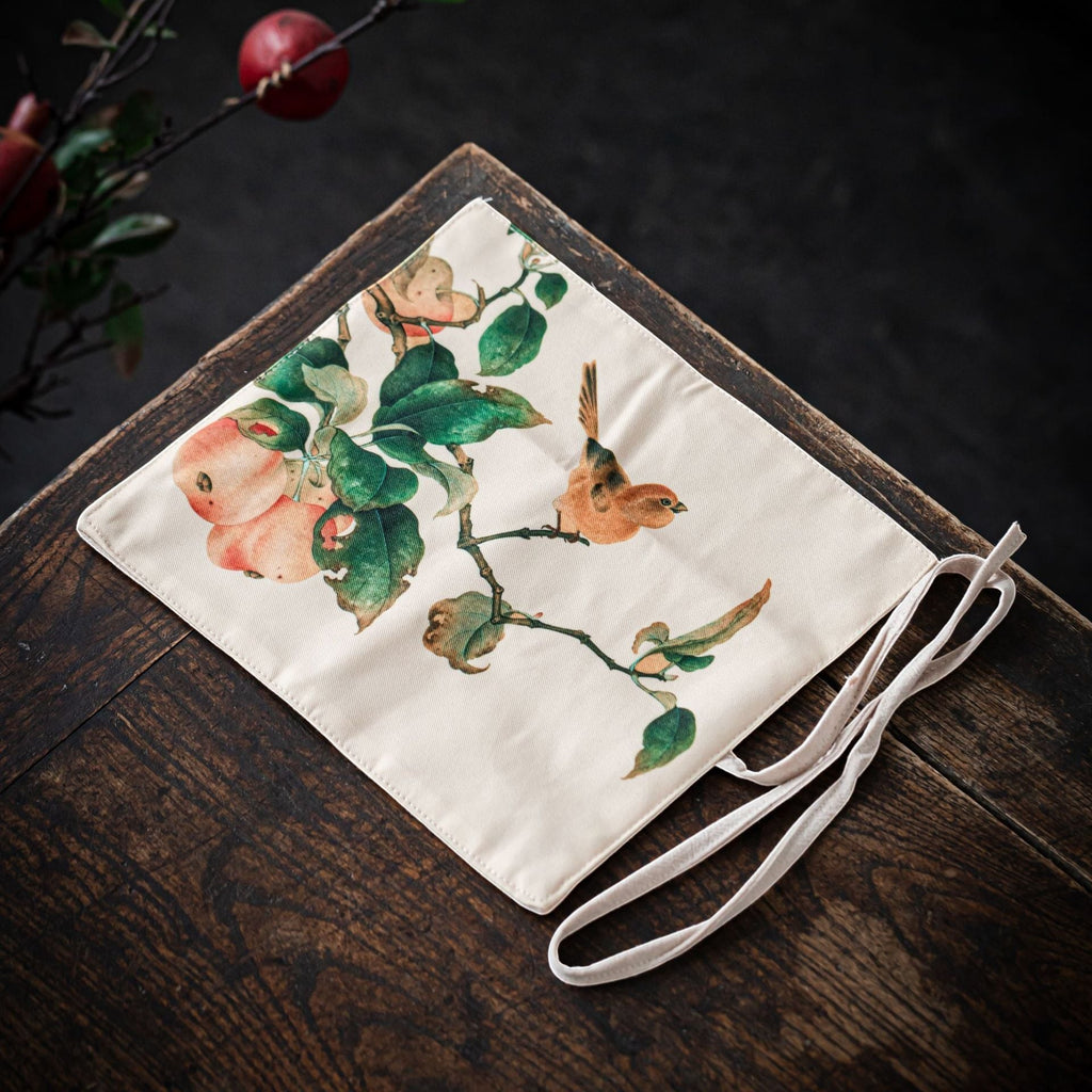 Peach Blossom Bird Gong Fu Cha travel mat displayed on a wooden tea table