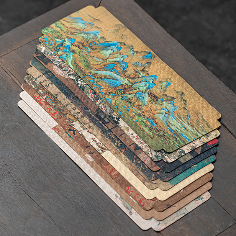 Stacked set of classical Chinese art tea mats showing multiple designs and colors